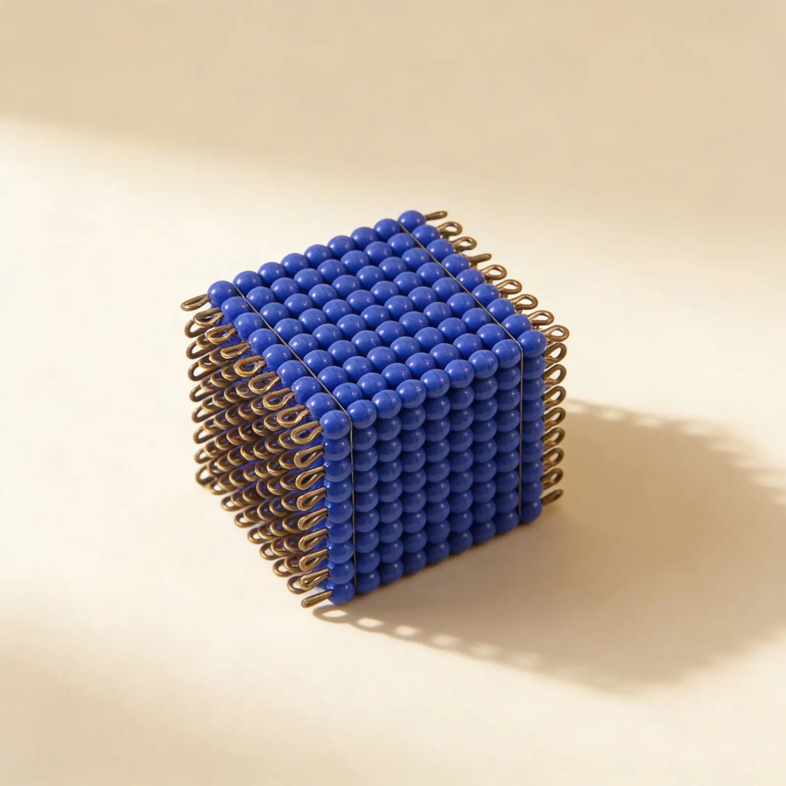 Glass Bead Cube of 9: Dark Blue Wire Frame Representing 729 Units: Side view
